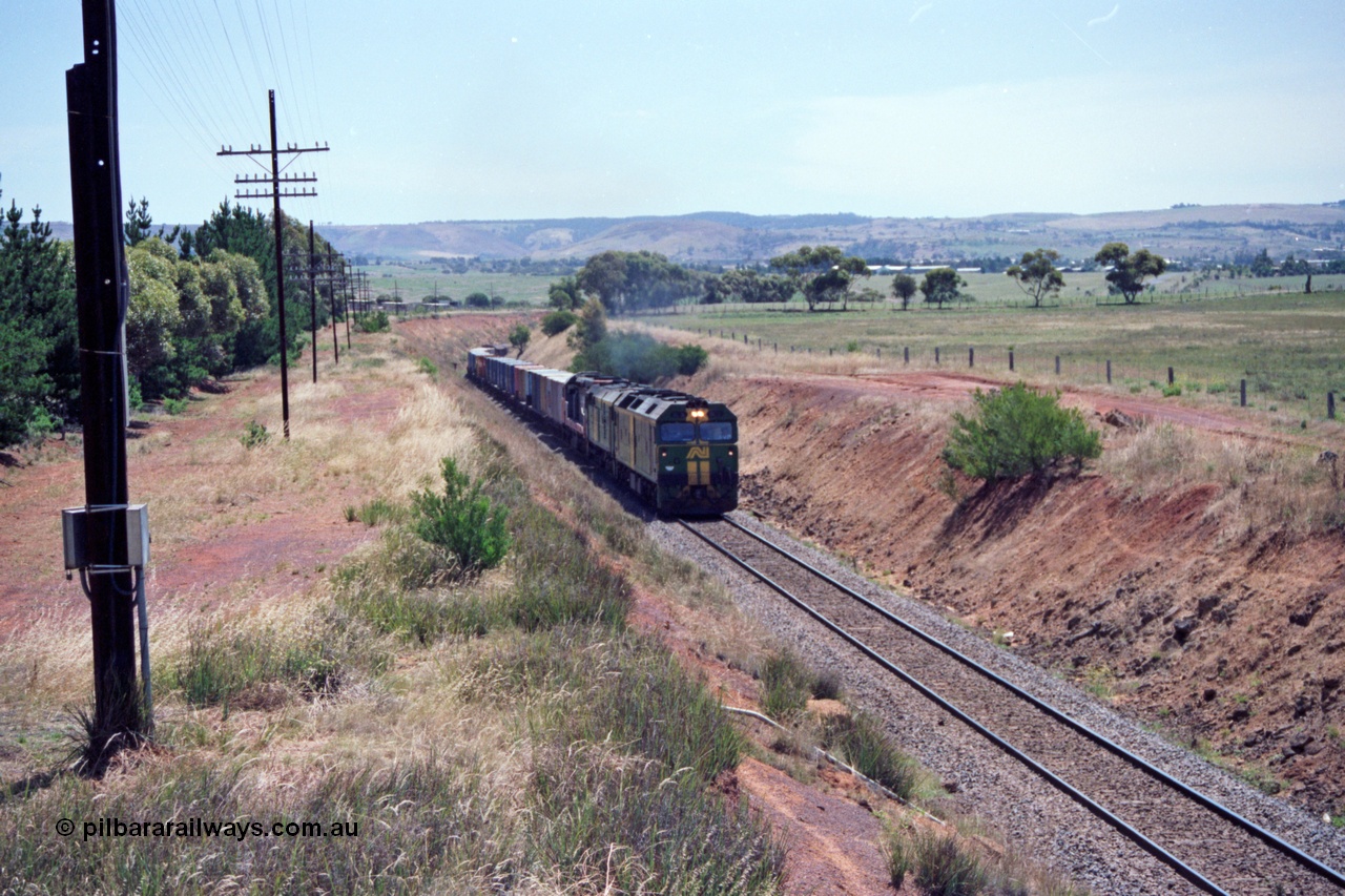 140-1-01
Parwan, up broad gauge Melbourne bound goods climbing Parwan Bank from Bacchus Marsh, could be 9150? Australian National locos BL class Clyde Engineering EMD model JT26C-2SS and 700 class AE Goodwin ALCo model DL500G combined with a V/Line C class provide the power.
Keywords: BL-class;Clyde-Engineering-Rosewater-SA;EMD;JT26C-2SS;