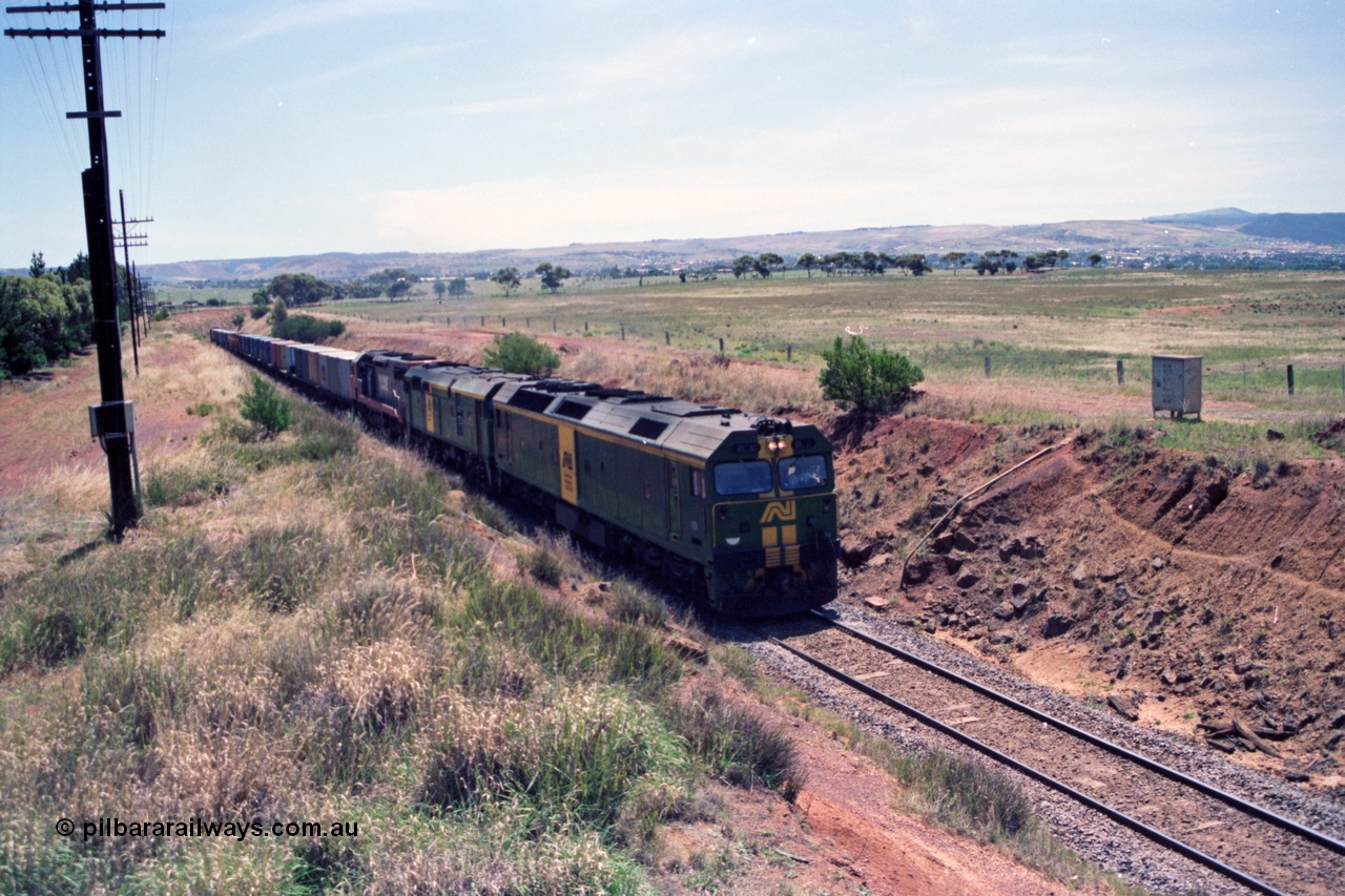 140-1-02
Parwan, up broad gauge Melbourne bound goods climbing Parwan Bank from Bacchus Marsh, could be 9150? Australian National locos BL class Clyde Engineering EMD model JT26C-2SS and 700 class AE Goodwin ALCo model DL500G combined with a V/Line C class provide the power.
Keywords: BL-class;Clyde-Engineering-Rosewater-SA;EMD;JT26C-2SS;