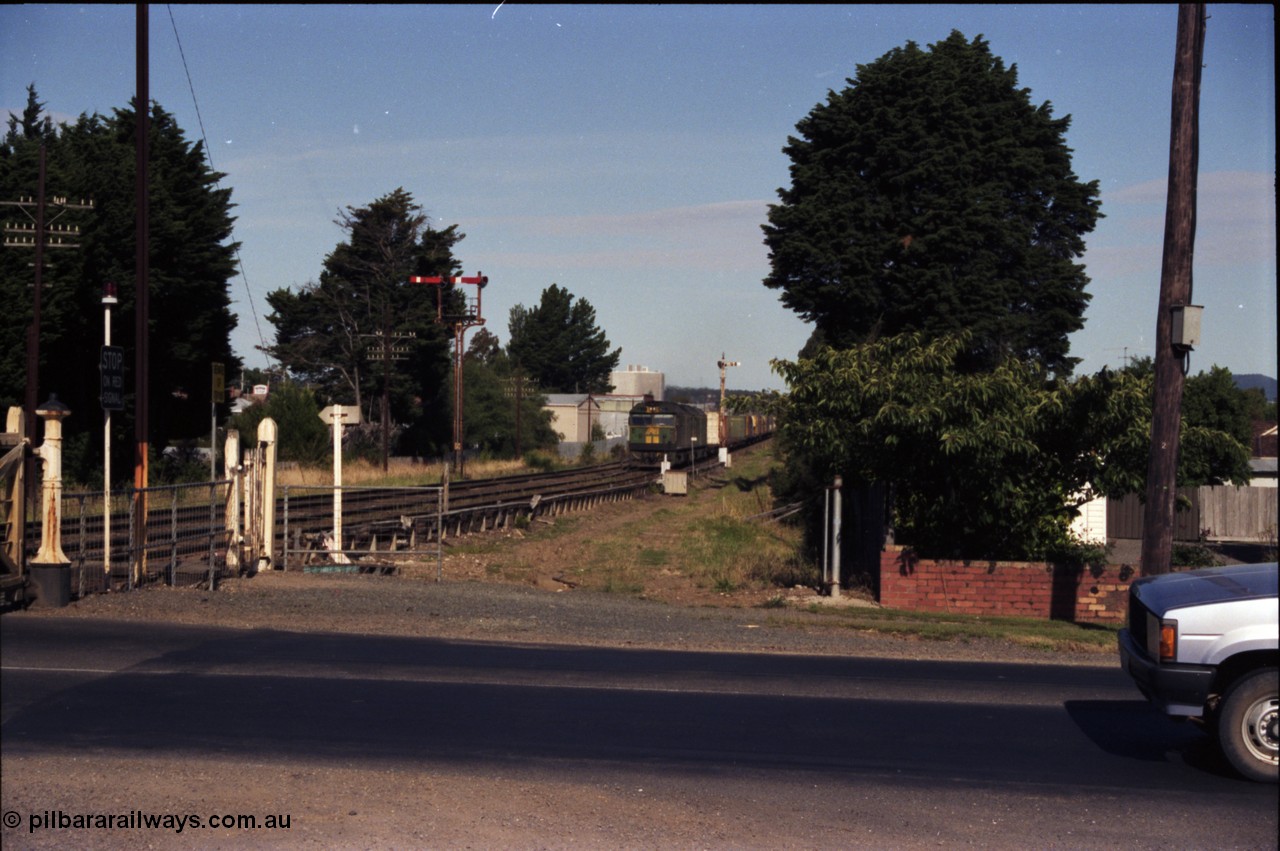 140-2-06
Ballarat, Linton Junction Signal Box, or Ballarat D, looking towards Ballarat, Australian National BL class BL 27 Clyde Engineering EMD model JT26C-2SS serial 83-1011 leads a down Adelaide bound goods train on approach to Linton Junction having just past semaphore signal post 20, semaphore signal post 19 is on the left, looking east across Gillies Street.
Keywords: BL-class;BL27;Clyde-Engineering-Rosewater-SA;EMD;JT26C-2SS;83-1011;