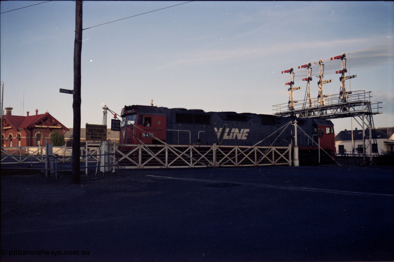 140-2-13
Ballarat station, V/Line broad gauge N class N 470 'City of Wangaratta' Clyde Engineering EMD model JT22HC-2 serial 86-1199 crosses Lydiard Street as it runs round the carriage set, through the interlocked gates and under the semaphore signal gantry.
Keywords: N-class;N470;Clyde-Engineering-Somerton-Victoria;EMD;JT22HC-2;86-1199;