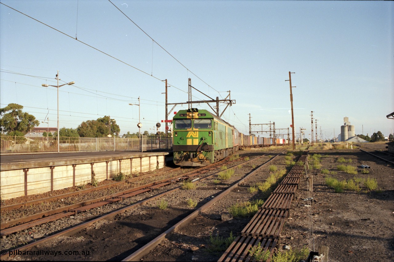 141-1-05
Sunshine, broad gauge down Adelaide goods train behind Australian National BL class BL 33 Clyde Engineering EMD model JT26C-2SS serial 83-1017 and V/Line G class G 515 Clyde Engineering EMD model JT26C-2SS serial 85-1243 pass platform No.3 as its consist crosses over the passenger lines from the Independent Through Lines heading the main western line, station platform, semaphore and disc signal posts, points, point rodding, looking east, Newport Loop Line on the right, GEB silo complex.
Keywords: BL-class;BL33;Clyde-Engineering-Rosewater-SA;EMD;JT26C-2SS;83-1017;