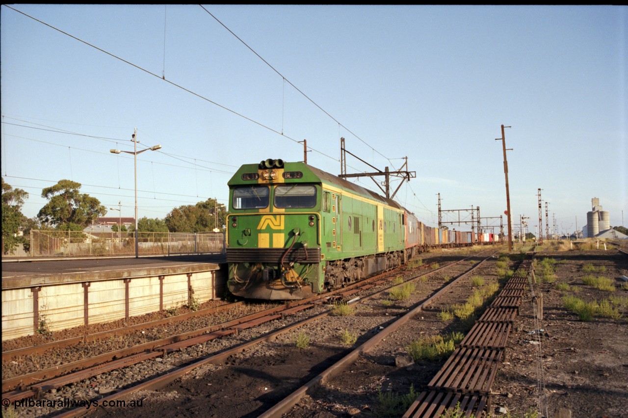 141-1-06
Sunshine, broad gauge down Adelaide goods train behind Australian National BL class BL 33 Clyde Engineering EMD model JT26C-2SS serial 83-1017 and V/Line G class G 515 Clyde Engineering EMD model JT26C-2SS serial 85-1243 pass platform No.3 as its consist crosses over the passenger lines from the Independent Through Lines heading the main western line, station platform, semaphore and disc signal posts, points, point rodding, looking east, Newport Loop Line on the right, GEB silo complex.
Keywords: BL-class;BL33;Clyde-Engineering-Rosewater-SA;EMD;JT26C-2SS;83-1017;