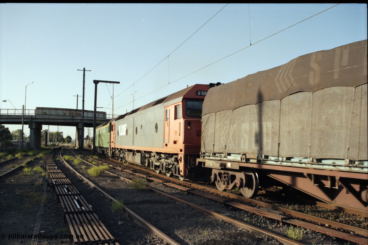 141-1-07
Sunshine, broad gauge down Adelaide goods train behind Australian National BL class BL 33 Clyde Engineering EMD model JT26C-2SS serial 83-1017 and V/Line G class G 515 Clyde Engineering EMD model JT26C-2SS serial 85-1243 pass platform No.3 with a down Adelaide bound goods train about to go under Hampshire Road overbridge, signal aspect of red over green, Clear Medium Speed, point rodding, former goods yard, V/Line broad gauge VQFY class bogie container flat waggon leads the consist.
Keywords: G-class;G515;Clyde-Engineering-Rosewater-SA;EMD;JT26C-2SS;85-1243;