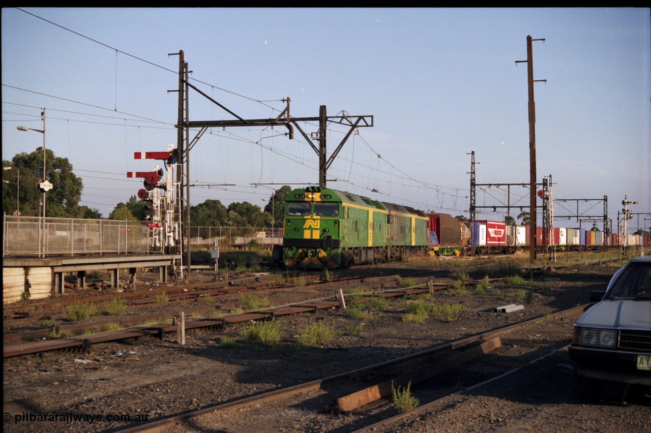 141-1-09
Sunshine, broad gauge Australian National BL class units BL 28 Clyde Engineering EMD model JT26C-2SS serial 83-1012 and BL 27 serial 83-1011 lead the second of the afternoon procession of down Adelaide bound goods trains out of Melbourne along the passenger lines and heading past platform No.3, semaphore and disc signal post, point rodding, station platforms.
Keywords: BL-class;BL28;Clyde-Engineering-Rosewater-SA;EMD;JT26C-2SS;83-1012;