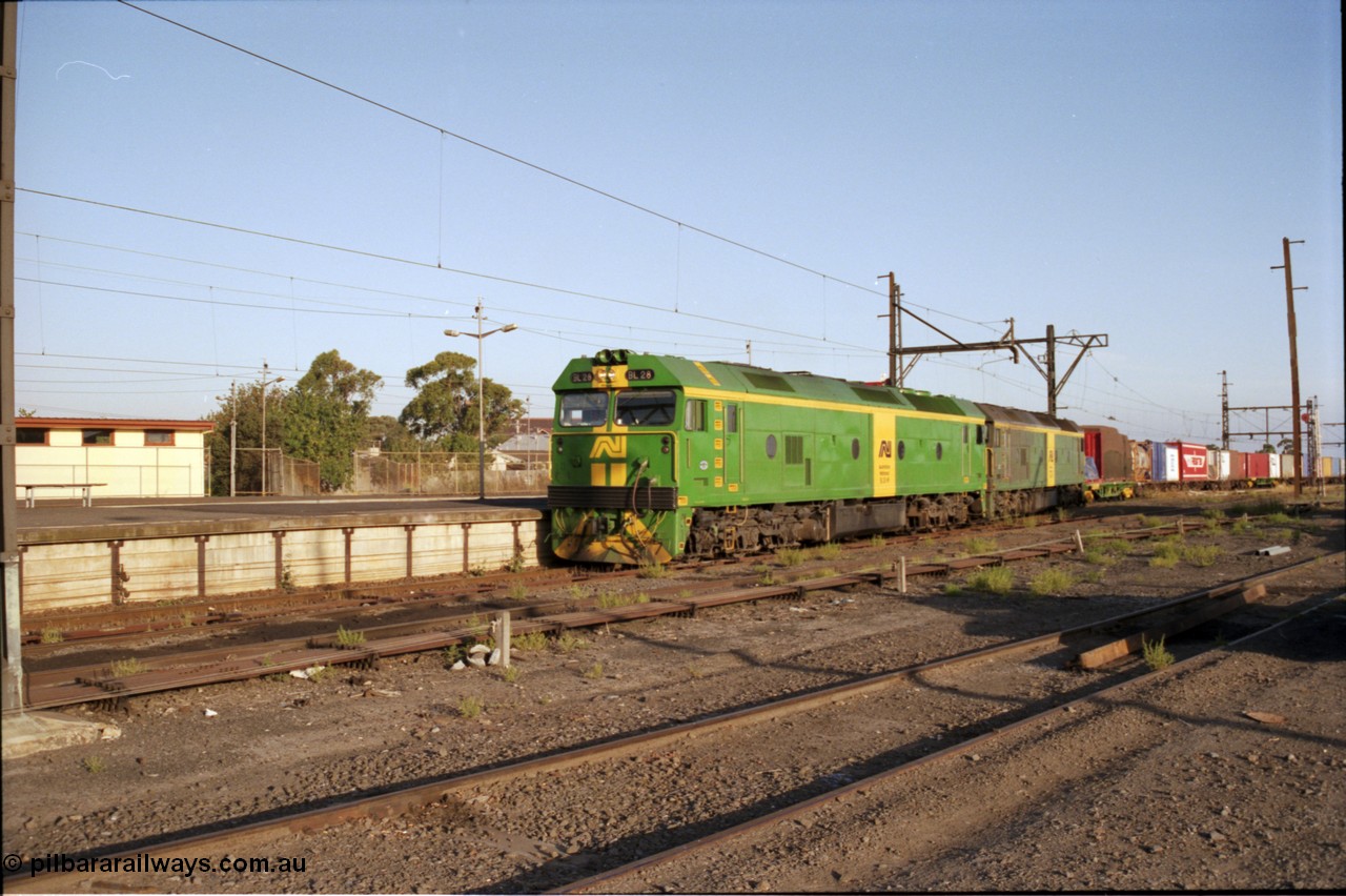 141-1-10
Sunshine, broad gauge Australian National BL class units BL 28 Clyde Engineering EMD model JT26C-2SS serial 83-1012 and BL 27 serial 83-1011 lead the second of the afternoon procession of down Adelaide bound goods trains out of Melbourne along the passenger lines and heading past platform No.3, point rodding, station platforms.
Keywords: BL-class;BL28;Clyde-Engineering-Rosewater-SA;EMD;JT26C-2SS;83-1012;