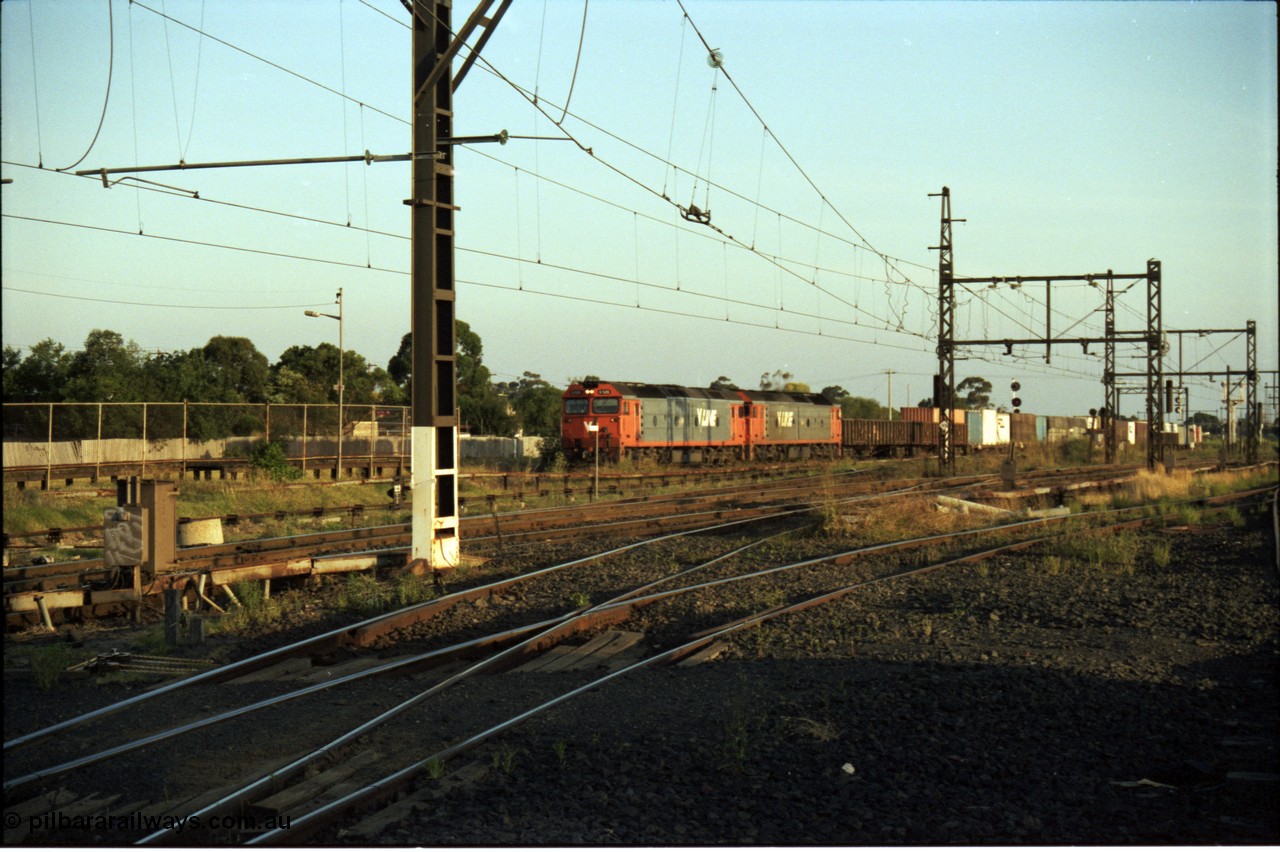 141-1-14
Sunshine Loop, standard gauge V/Line G class units double head a down goods train seen running through the long since removed crossing loop, looking from former broad gauge goods yard across broad gauge northern and western lines.
Keywords: G-class;Clyde-Engineering-Somerton-Victoria;EMD;JT26C-2SS;