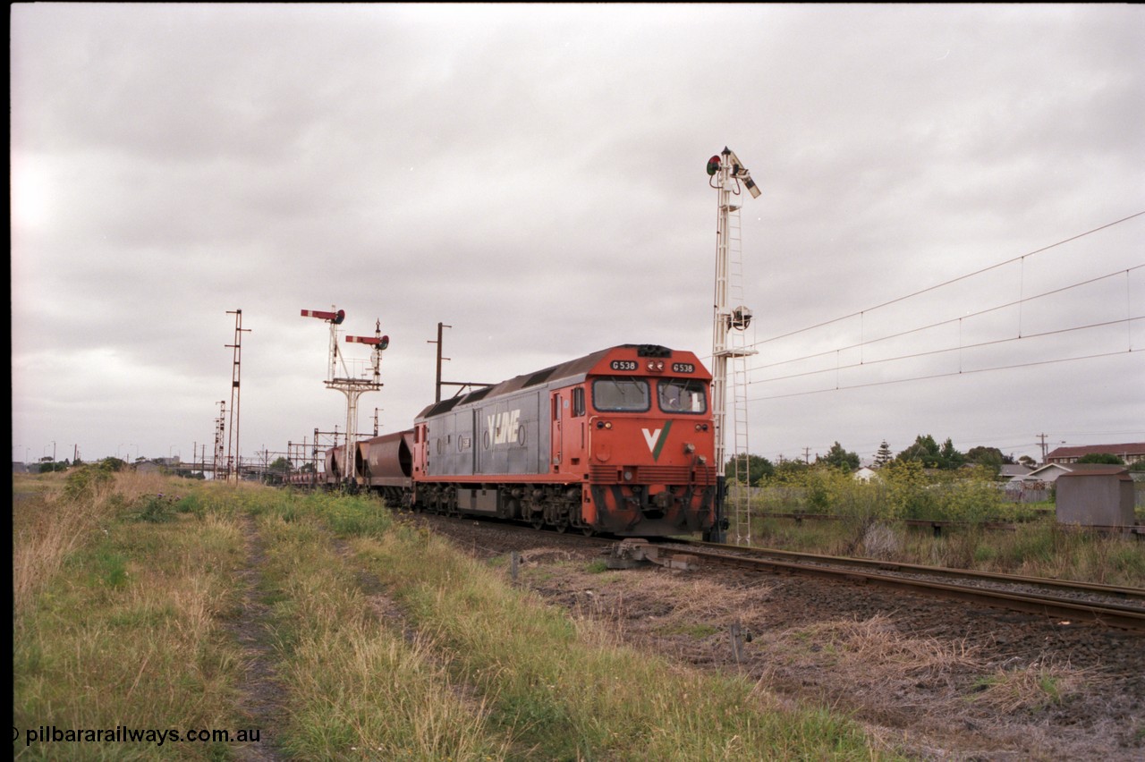 141-1-18
Sunshine, broad gauge V/Line G class loco G 538 Clyde Engineering EMD model JT26C-2SS serial 89-1271 leads the up afternoon Apex Quarry train to Brooklyn as it runs across the passenger lines and onto the Newport Loop Line, the semaphore signal post 36 protects down trains off this line. The dual control point machine is for the points into the GEB sidings, the up home semaphore and disc signal post 49 is pulled off for the train to head towards Brooklyn.
Keywords: G-class;G538;Clyde-Engineering-Somerton-Victoria;EMD;JT26C-2SS;89-1271;