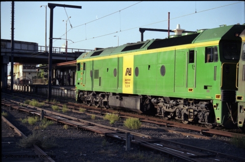141-1-11
Sunshine, broad gauge Australian National BL class BL 28 Clyde Engineering EMD model JT26C-2SS serial 83-1012 runs along platform No.3 with a down Adelaide bound goods train, station platform, station building, point rodding and signal wires, signal box in the background, trailing view.
Keywords: BL-class;BL28;Clyde-Engineering-Rosewater-SA;EMD;JT26C-2SS;83-1012;