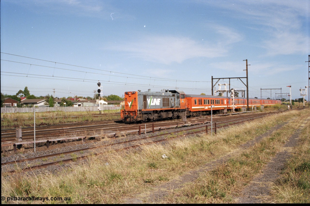 141-2-02
Sunshine, broad gauge V/Line P class P 14 Clyde Engineering EMD model G18HBR serial 84-1208 rebuilt from T 330 Clyde Engineering EMD model G8B serial 56-85 with a six car H set push-pull down passenger train with fellow P class P 21 serial 84-1214 rebuilt from T 338 serial 56-114 on the rear, searchlight signal post to left is the Up Home for the standard gauge Sunshine Loop, the Newport - Sunshine Loop Line can be seen in the foreground, the semaphore signal at right if for the Newport Loop Line, disc for the GEB Sidings, the double doll semaphore signal post and disc post above the lead carriage is for the Independent Through Goods Lines.
Keywords: P-class;P14;Clyde-Engineering-Somerton-Victoria;EMD;G18HBR;84-1208;rebuild;