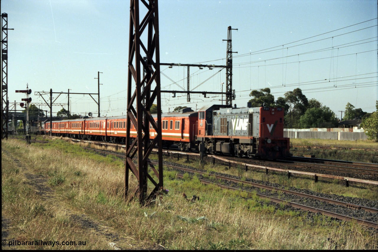 141-2-03
Sunshine, broad gauge V/Line P class P 21 Clyde Engineering EMD model G18HBR serial 84-1214 rebuilt from T 338 Clyde Engineering EMD model G8B serial 56-114 on the rear with a six car H set push-pull passenger train with fellow P class P 14 serial 84-1208 rebuilt from T 330 serial 56-85 on the front, trailing view, semaphore signal post 35 is at the very left of the image, the train is just entering Platform No.2.
Keywords: P-class;P21;Clyde-Engineering-Somerton-Victoria;EMD;G18HBR;84-1214;rebuild;