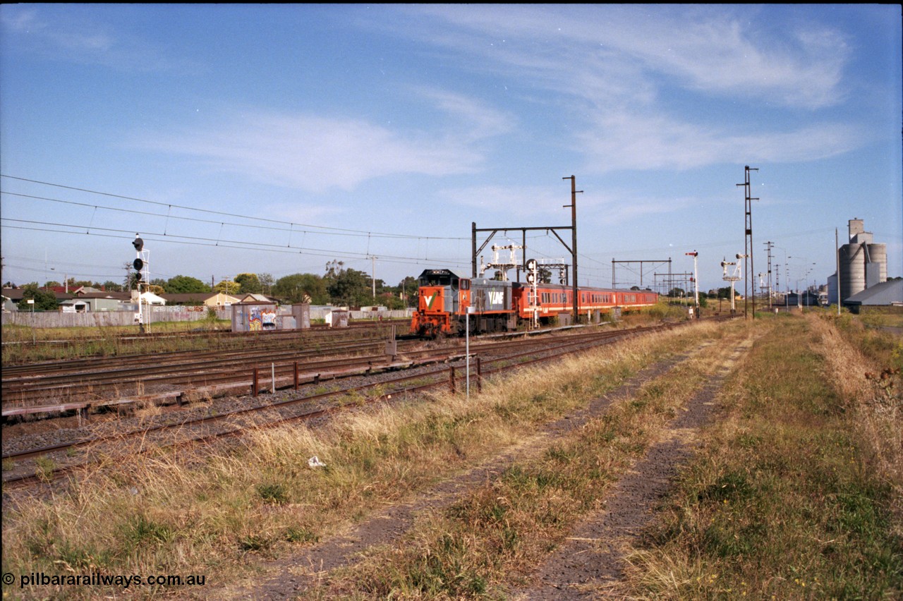 141-2-05
Sunshine, now there's a lot going on here apart from the Broad gauge V/Line P class P 17 Clyde Engineering EMD model G18HBR serial 84-1216 rebuilt from T 327 Clyde Engineering EMD model G8B serial 56-78 with a four car H set on a down passenger train, we have the signals from the left, the Up Home searchlight signal post for the standard gauge Sunshine Loop, disc signal post 31 and double doll semaphore signal post 31B for the Independent Through Lines, searchlight signal post 71 which is controlling the train, the signal gantry in the left background for the standard gauge Sunshine Loop, on the right of the train semaphore signal post 49 for the Newport Loop Line, double doll semaphore signal post 36 for down trains off the Newport Loop Line and then offset semaphore signal post 50 also for down trains out of the GEB sidings.
Keywords: P-class;P17;Clyde-Engineering-Somerton-Victoria;EMD;G18HBR;84-1216;rebuild;