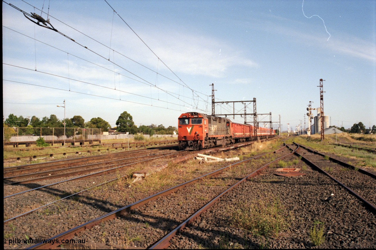 141-2-09
Sunshine, broad gauge V/Line down Swan Hill passenger train with N class leader N 451 'City of Portland' Clyde Engineering EMD model JT22HC-2 serial 85-1219, two D vans and N set, Newport Loop Line and GEB sidings can be seen on the right, the standard gauge platform can be seen at left.
Keywords: N-class;N451;Clyde-Engineering-Somerton-Victoria;EMD;JT22HC-2;85-1219;