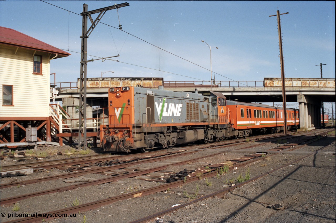 141-2-11
Sunshine, broad gauge V/Line P class P 18 Clyde Engineering EMD model G18HBR serial 84-1211 rebuilt from T 339 Clyde Engineering EMD model G8B serial 56-115 leads an H set underneath the Hampshire Road overbridge with a down Bacchus Marsh passenger train departing platform No.3 and heading west passing the back of the signal box, point rodding and signal wires, interlocking, former goods yard.
Keywords: P-class;P18;Clyde-Engineering-Somerton-Victoria;EMD;G18HBR;84-1211;rebuild;