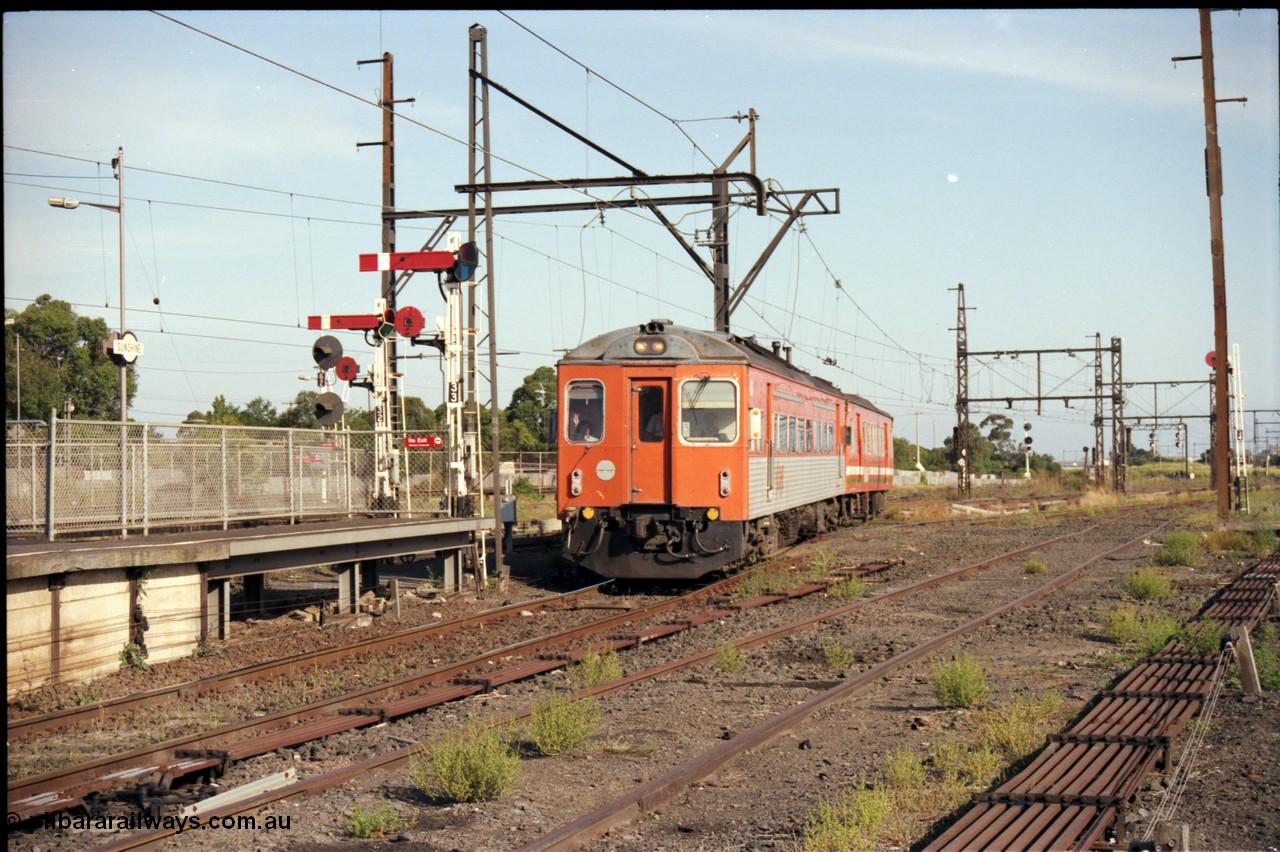 141-2-13
Sunshine, broad gauge V/Line Tulloch Ltd DRC class diesel rail car and MTH class trailer carriage arrive at platform No.3 past semaphore and disc signal post 33 with a Bacchus Marsh bound down passenger service, looking east, point rodding, former goods yard.
Keywords: DRC-class;Tulloch-Ltd-NSW;