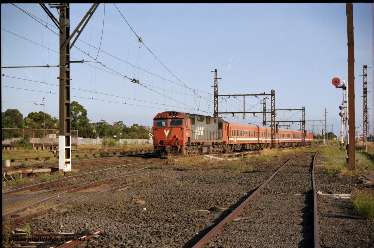 141-2-20
Sunshine, V/Line broad gauge N class N 470 'City of Wangaratta' Clyde Engineering EMD model JT22HC-2 serial 86-1199 with a five car Z set with D van on a down passenger service, taken from the former goods yard looking east.
Keywords: N-class;N470;Clyde-Engineering-Somerton-Victoria;EMD;JT22HC-2;86-1199;