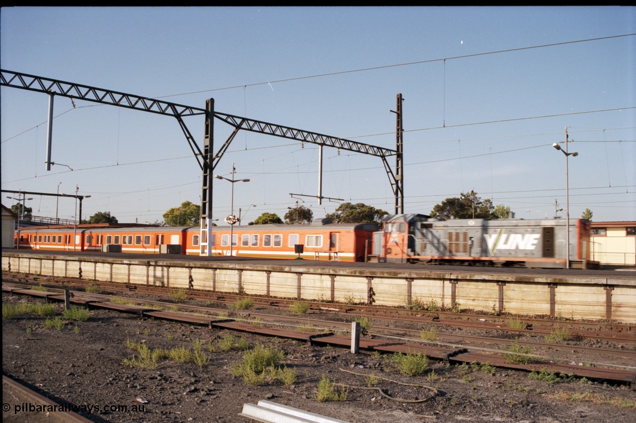 141-2-21
Sunshine, V/Line broad gauge P class P 21 Clyde Engineering EMD model G18HBR serial 84-1214 rebuilt from T 338 Clyde Engineering EMD model G8B serial 56-114 returning with the double H set 'push-pull' up passenger service through platform No.1, platform No.3 and point rodding in foreground, blurred.
Keywords: P-class;P21;Clyde-Engineering-Somerton-Victoria;EMD;G18HBR;84-1214;rebuild;