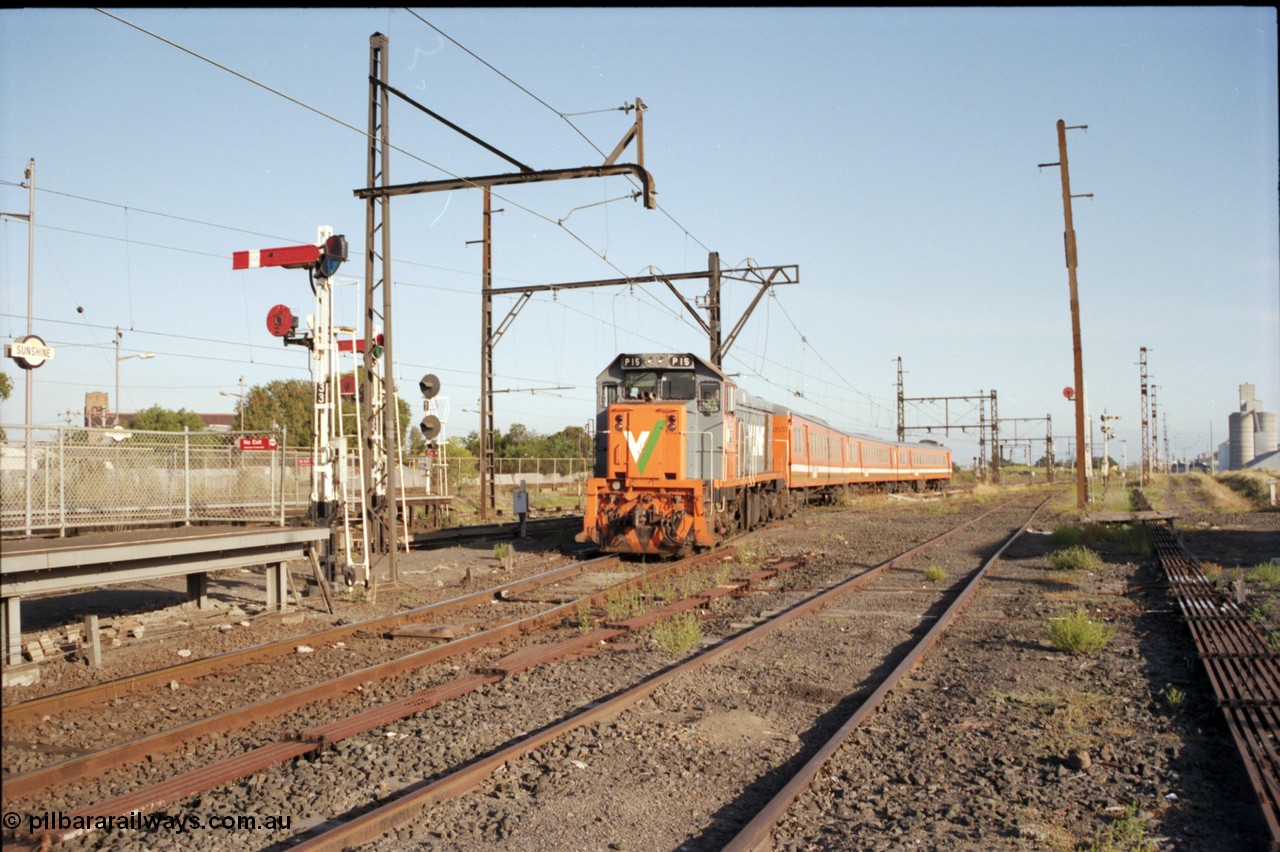 141-2-23
Sunshine, V/Line broad gauge P class P 15 Clyde Engineering EMD model G18HBR serial 84-1209 rebuilt from T 344 Clyde Engineering EMD model G8B serial 56-127 with a three car H set on an afternoon down service to Bacchus Marsh via platform No.3, the track to the Newport Loop Line runs straight up on the right, station platform, semaphore, disc and searchlight signals, point rodding, yard view from former goods yard.
Keywords: P-class;P15;Clyde-Engineering-Somerton-Victoria;EMD;G18HBR;84-1209;rebuild;