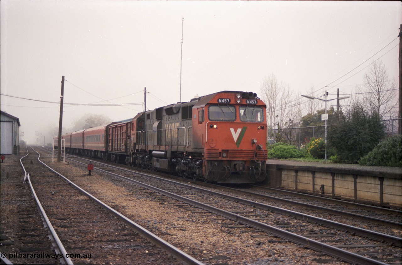 142-1-09
Euroa station platform, V/Line broad gauge N class N 457 'City of Mildura' Clyde Engineering EMD model JT22HC-2 serial 85-1225 leads an up Albury broad gauge passenger train of D van and 5 car N set, catch point and indicators.
Keywords: N-class;N457;Clyde-Engineering-Somerton-Victoria;EMD;JT22HC-2;85-1225;