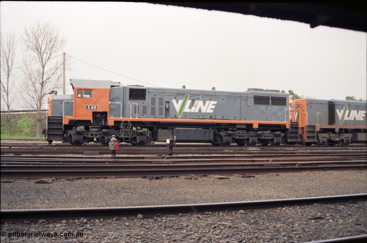 142-1-27
Benalla yard view, stabled broad gauge Wodonga goods train 9303 with V/Line X class X 48 Clyde Engineering EMD model G26C serial 75-795, side view, dwarf disc signal 13 and point indicator.
Keywords: X-class;X48;Clyde-Engineering-Rosewater-SA;EMD;G26C;75-795;