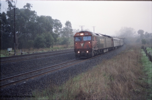 142-1-06
Seymour, V/Line standard gauge G class G 526 Clyde Engineering EMD model JT26C-2SS serial 88-1256 leads the south bound Melbourne Express on a very foggy morning.
Keywords: G-class;G526;Clyde-Engineering-Somerton-Victoria;EMD;JT26C-2SS;88-1256;