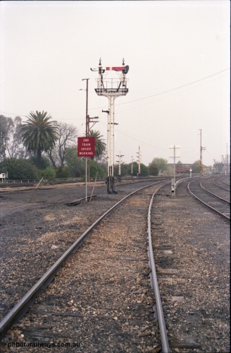 142-1-20
Benalla station yard view from Yarrawonga line, signal post 29B mostly stripped, disc signal posts 29 and 32 stripped in the background, workshops building visible is the distance, Sidings J and K visible at right.
