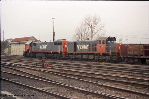 142-1-30
Benalla yard view, stabled broad gauge Wodonga goods train 9303 with V/Line X class X 48 Clyde Engineering EMD model G26C serial 75-795 and T class T 408 Clyde Engineering EMD model G18B serial 68-624, dwarf disc signal 10, track view, B signal box, trailing view.
Keywords: T-class;T408;Clyde-Engineering-Granville-NSW;EMD;G18B;68-624;