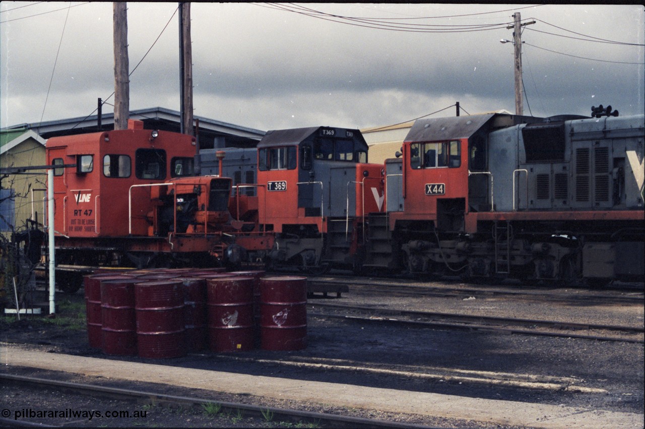 142-2-19
Wodonga loco depot, close up view across service roads, broad gauge V/Line units RT class rail tractor RT 47, T class T 369 Clyde Engineering EMD model G8B serial 64-324 and X class X 44 Clyde Engineering EMD model G26C serial 70-707.
Keywords: X-class;X44;Clyde-Engineering-Granville-NSW;EMD;G26C;70-707;