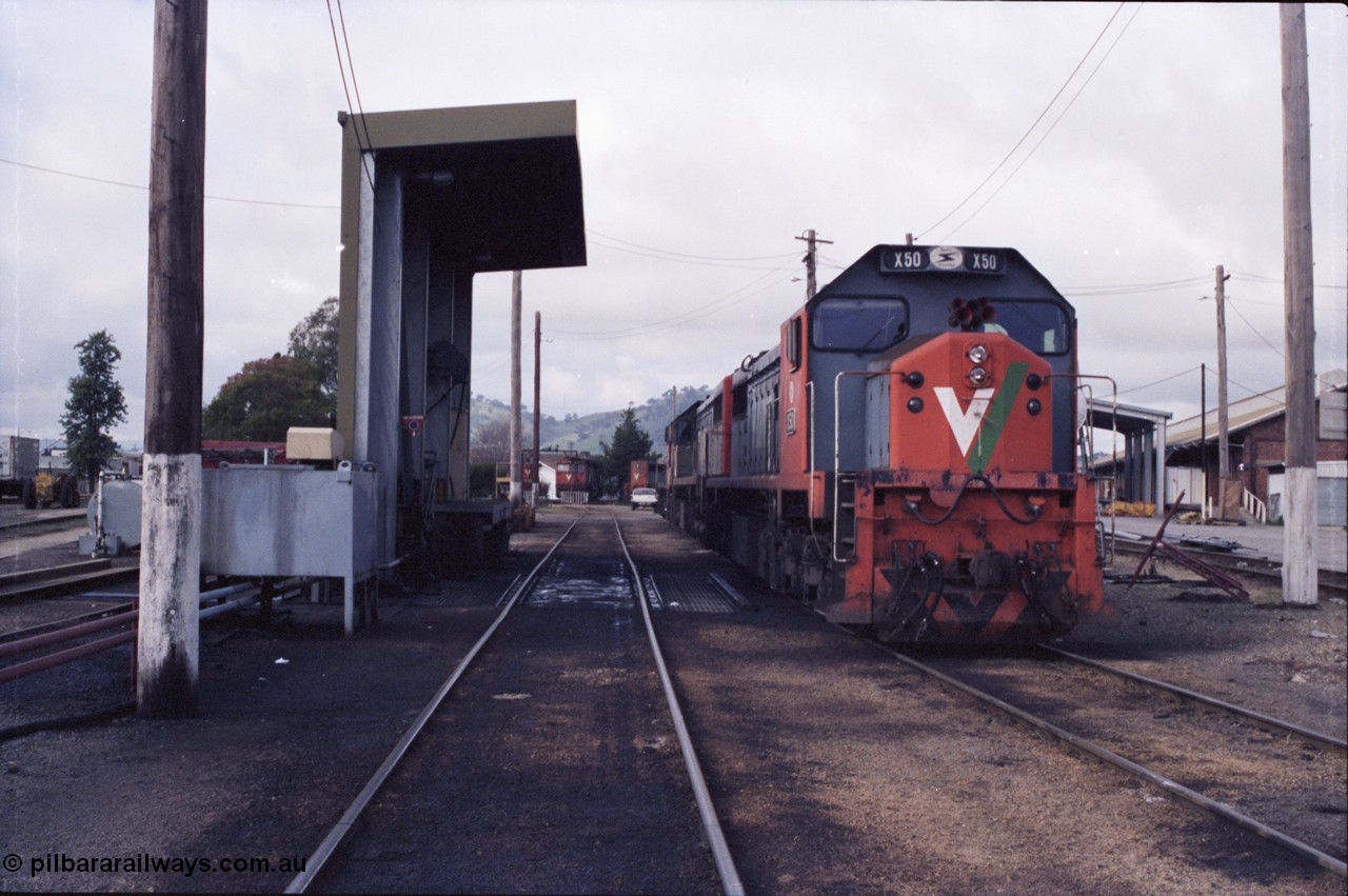 142-2-22
Wodonga loco depot fuel point, V/Line broad gauge locos lined up waiting sign on time include X class X 50 Clyde Engineering EMD model G26C serial 75-797, N class in the distance with turntable.
Keywords: X-class;X50;Clyde-Engineering-Rosewater-SA;EMD;G26C;75-797;