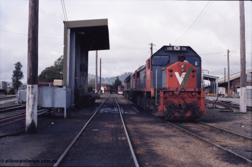142-2-22
Wodonga loco depot fuel point, V/Line broad gauge locos lined up waiting sign on time include X class X 50 Clyde Engineering EMD model G26C serial 75-797, N class in the distance with turntable.
Keywords: X-class;X50;Clyde-Engineering-Rosewater-SA;EMD;G26C;75-797;