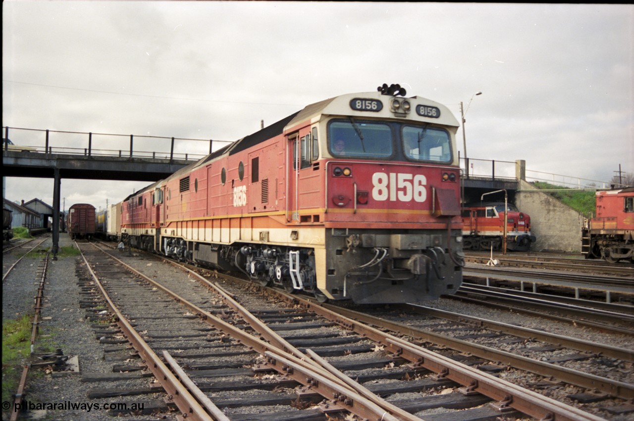 142-3-00
Albury station yard, standard gauge NSWSRA candy liveried 81 class locos 8156 Clyde Engineering EMD model JT26C-2SS serial 84-1075 and 8180 serial 85-1099 bring a south bound down goods train into the platform where they will cut off and head to loco and V/Line power will attach and continue to Melbourne on the now up goods.
Keywords: 81-class;8180;Clyde-Engineering-Kelso-NSW;EMD;JT26C-2SS;85-1099;