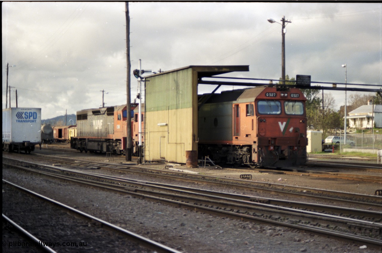 142-3-02
Albury loco depot fuel point, standard gauge V/Line G class G 527 Clyde Engineering EMD model JT26C-2SS serial 88-1257 and C class C 503 Clyde Engineering EMD model GT26C serial 76-826 await there call to duty, semaphore signal, overhead pipe line is for fuel delivery.
Keywords: G-class;G527;Clyde-Engineering-Somerton-Victoria;EMD;JT26C-2SS;88-1257;