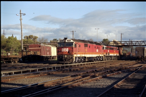 142-3-10
Albury station yard, standard gauge NSWSRA candy liveried pair of 81 class 8156 Clyde Engineering EMD model JT26C-2SS serial 84-1075 and 44 class 4466 AE Goodwin ALCo model DL500B serial G3421-06 depart the yard light engine bound for the paper mill siding just north of Albury.
Keywords: 81-class;8156;Clyde-Engineering-Kelso-NSW;EMD;JT26C-2SS;84-1075;