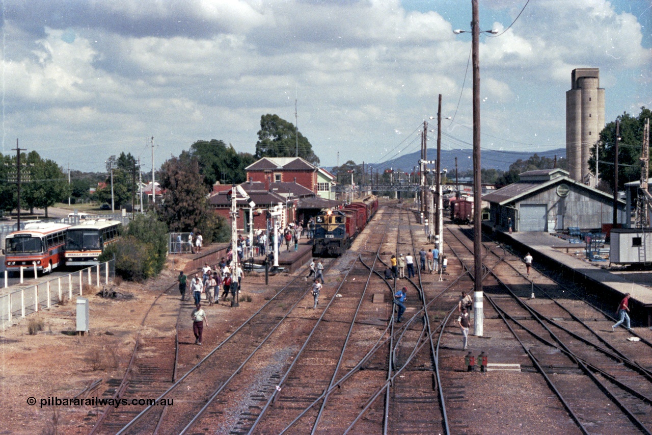 143-05
Wangaratta station yard overview looking south from footbridge, VR liveried Y class Y 133 Clyde Engineering EMD model G6B serial 65-399 with the board gauge down Wahgunyah Special 'Stringybark Express' at the platform pauses for the photo stop, controlling rail enthusiasts can be a lot like herding cats!!, the fully interlocked yard and 18th century infrastructure clearly on display here, semaphore signal Post 20 is pulled off for departure, station building and platform, elevated signal box, signal posts and interlocking, goods shed and water tower.
Keywords: Y-class;Y133;Clyde-Engineering-Granville-NSW;EMD;G6B;65-399;