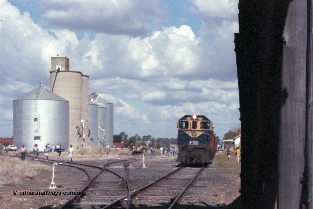 143-20
Rutherglen yard overview, broad gauge VR liveried Y class Y 133 Clyde Engineering EMD model G6B serial 65-399 with the down Wahgunyah 'Stringybark Express' mixed special is framed by the Williamstown and Ascom silos on the left and the piers for the over bridge of High St as it pauses for safe working and a 'photo stop'.
Keywords: Y-class;Y133;Clyde-Engineering-Granville-NSW;EMD;G6B;65-399;