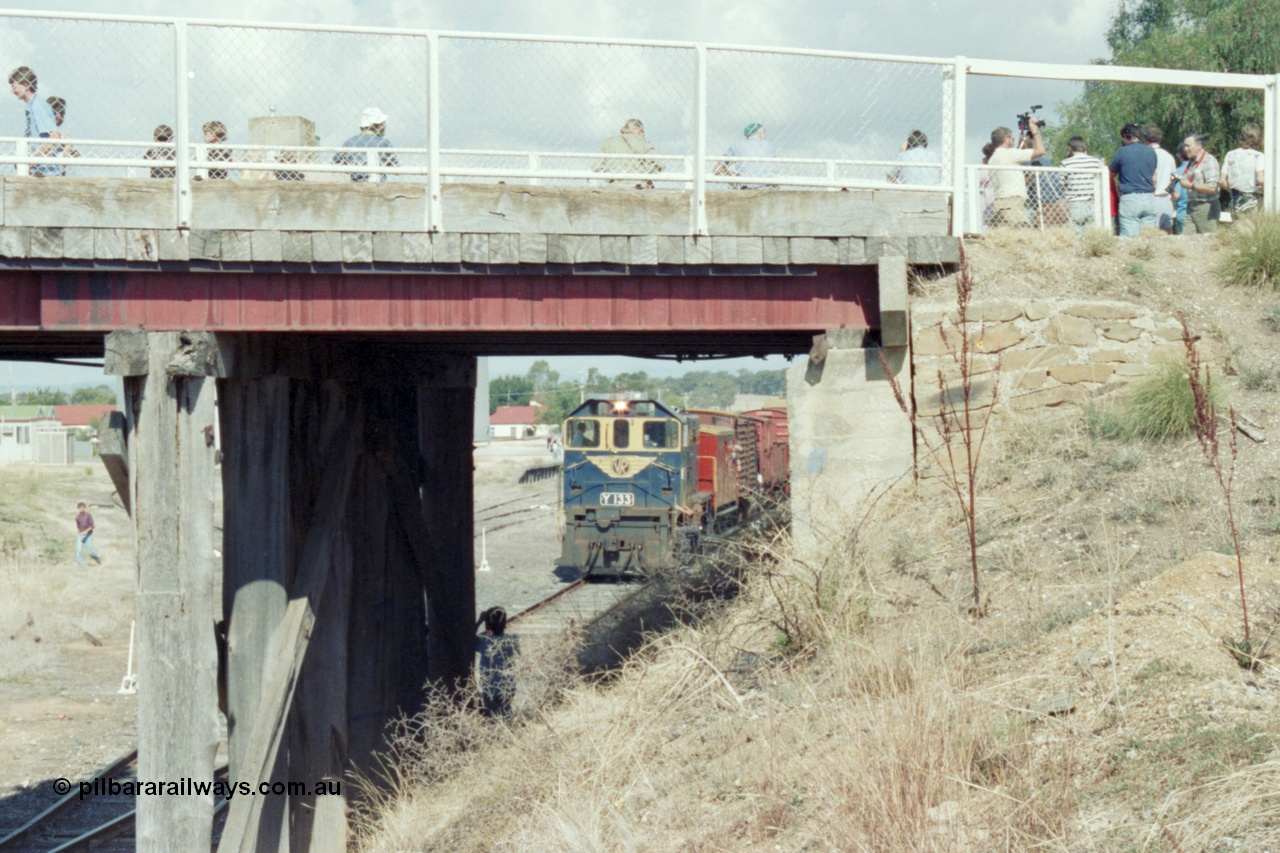 143-21
Rutherglen, view through the piers of the High St over bridge, broad gauge VR liveried Y class Y 133 Clyde Engineering EMD model G6B serial 65-399 departs as a plethora of enthusiasts capture the moment of the last down 'Stringybark Express' mixed train.
Keywords: Y-class;Y133;Clyde-Engineering-Granville-NSW;EMD;G6B;65-399;