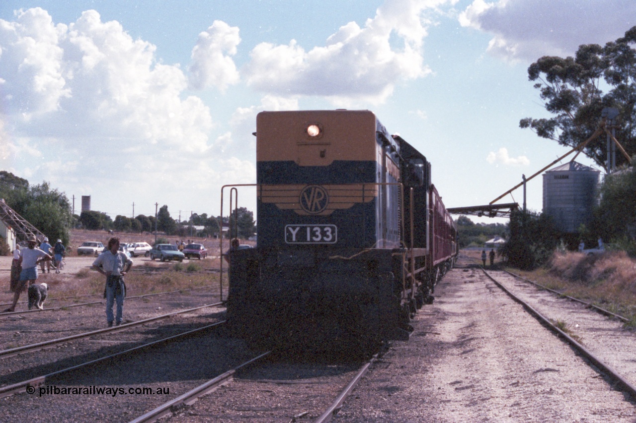 143-30
Wahgunyah, broad gauge VR liveried Y class Y 133 Clyde Engineering EMD model G6B serial 65-399 sits on the point of the up 'Stringybark Express' mixed special as it awaits departure time. The silo structure on the right stands on the former station building platform.
Keywords: Y-class;Y133;Clyde-Engineering-Granville-NSW;EMD;G6B;65-399;