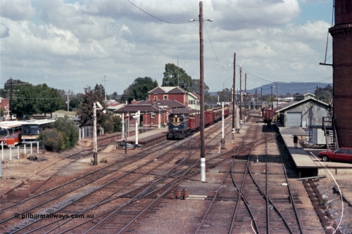 143-04
Wangaratta station yard overview looking south from footbridge, VR liveried Y class Y 133 Clyde Engineering EMD model G6B serial 65-399 brings the board gauge down Wahgunyah Special 'Stringybark Express' to a stop at the platform, the fully interlocked yard and 18th century infrastructure clearly on display here, semaphore signal Post 20 is pulled off for departure, station building and platform, elevated signal box, signal posts and interlocking, goods shed and water tower.
Keywords: Y-class;Y133;Clyde-Engineering-Granville-NSW;EMD;G6B;65-399;