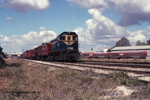 143-26
Wahgunyah, broad gauge VR liveried Y class Y 133 Clyde Engineering EMD model G6B serial 65-399 leads the arriving 'Stringybark Express' mixed special into the yard past some V/Line VOFX type bogie super phosphate waggons and sheds on the right.
Keywords: Y-class;Y133;Clyde-Engineering-Granville-NSW;EMD;G6B;65-399;