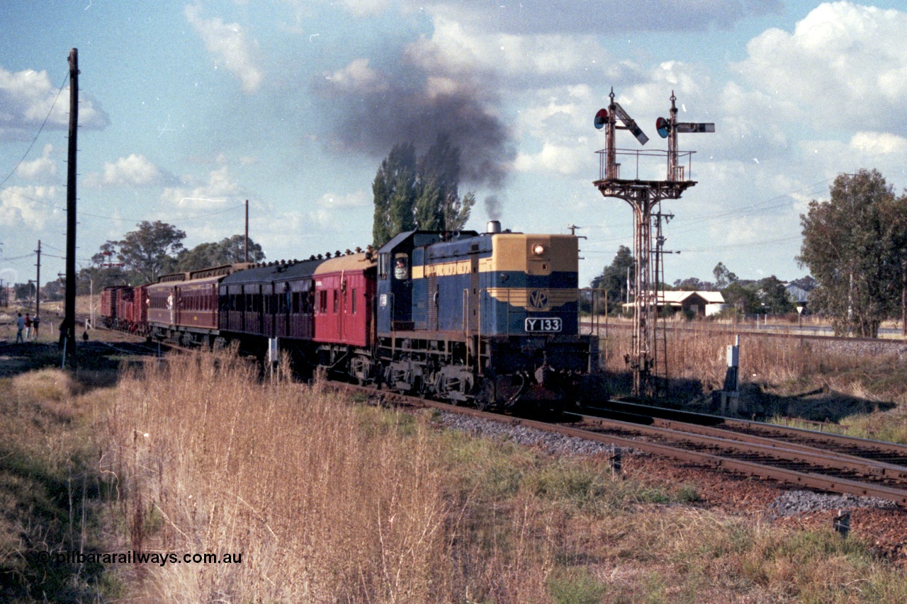 144-05
Springhurst, up 'Stringybark Express' Wahgunyah mixed special blasts out of No. 2 Rd bound for Wangaratta hauled by VR liveried broad gauge Y class Y 133 Clyde Engineering EMD model G6B serial 65-399 passing semaphore signal Post 3 with the right arm pulled off for No. 2 Rd to Main Line, the standard gauge line is elevated on the right.
Keywords: Y-class;Y133;Clyde-Engineering-Granville-NSW;EMD;G6B;65-399;