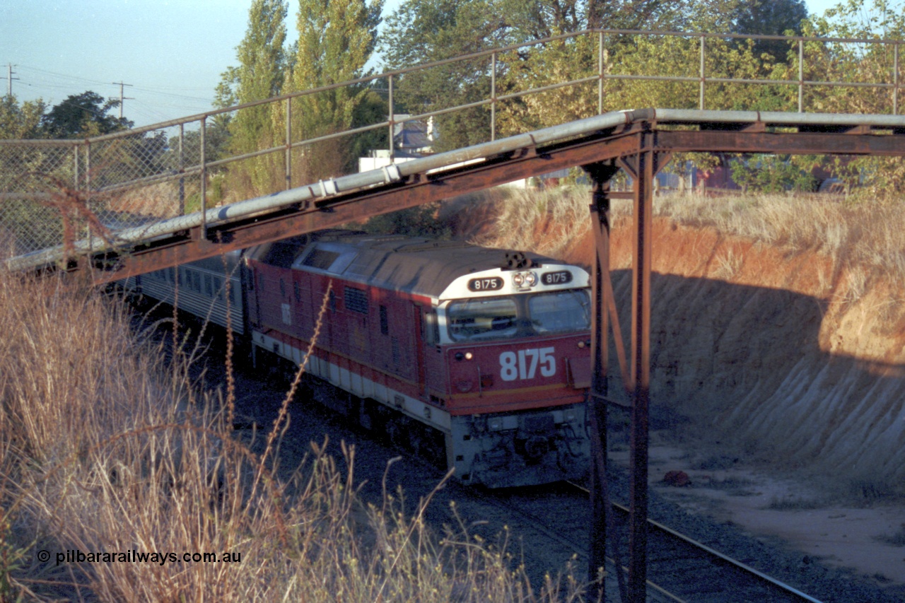 144-12
Wangaratta, standard gauge NSWSRA 81 class 8175 Clyde Engineering EMD model JT26C-2SS serial 85-1094, candy livery, leads the up Inter-Capital Daylight through the cutting and under the footbridge on the way to Melbourne.
Keywords: 81-class;8175;Clyde-Engineering-Kelso-NSW;EMD;JT26C-2SS;85-1094;