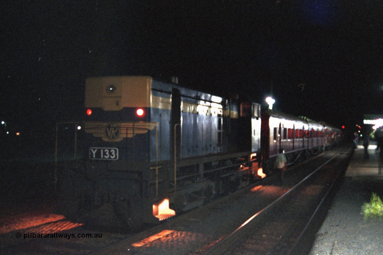 144-21
Euroa station platform view, broad gauge VR liveried Y class Y 133 Clyde Engineering EMD model G6B serial 65-399 with the up Wahgunyah 'Stringybark Express' mixed sits in No. 2 Rd awaiting a cross, night time exposure.
Keywords: Y-class;Y133;Clyde-Engineering-Granville-NSW;EMD;G6B;65-399;