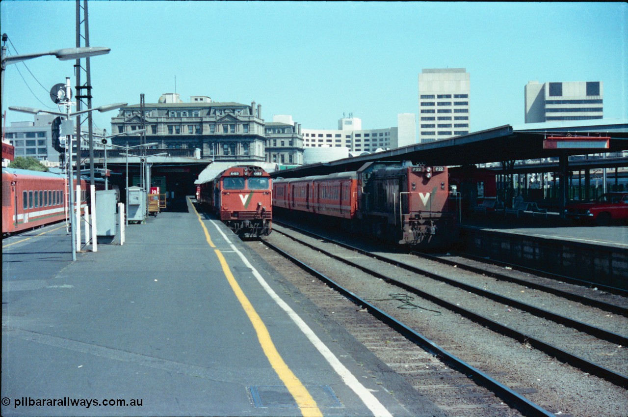 145-10
Spencer Street Station platform view of Platforms 4 and 5, broad gauge V/Line locos N class N 469 'City of Morwell' Clyde Engineering EMD model JT22HC-2 serial 86-1198 with N set and P class P 22 Clyde Engineering EMD model G18HBR serial 84-1215 rebuilt from T 328 Clyde Engineering EMD model G8B serial 56-80 with H set ready to run afternoon down passenger trains, note the private car on the platform.
Keywords: N-class;N469;Clyde-Engineering-Somerton-Victoria;EMD;JT22HC-2;86-1198;