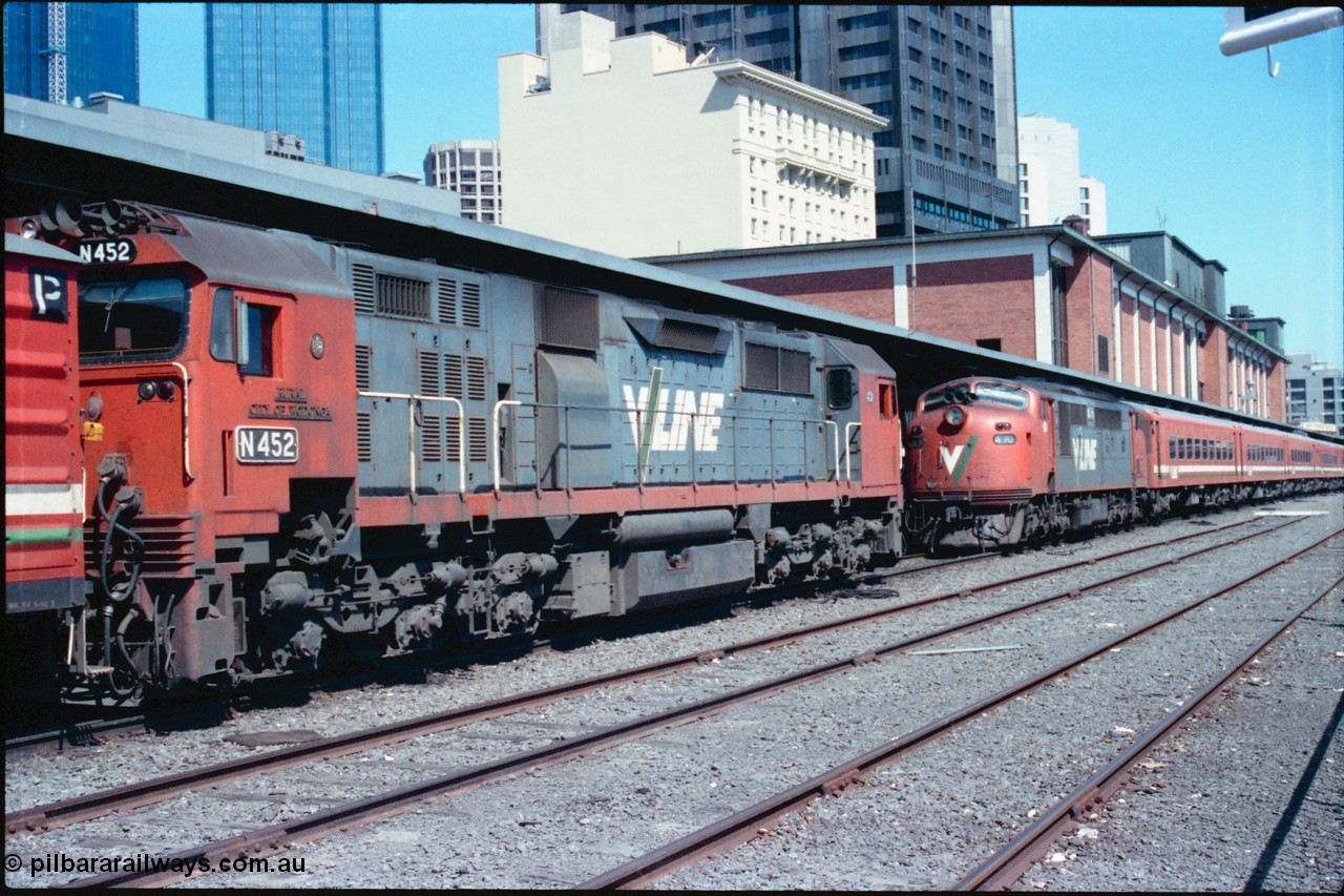 145-12
Spencer Street Station dual gauge Platform Number 1, broad gauge V/line locos N class N 452 'Rural City of Wodonga' Clyde Engineering EMD model JT22HC-2 serial 85-1220 and A class A 70 Clyde Engineering EMD model AAT22C-2R serial 84-1187 rebuilt from B 70 Clyde Engineering EMD model ML2 serial ML2-11 with N set.
Keywords: A-class;A70;Clyde-Engineering-Rosewater-SA;EMD;AAT22C-2R;84-1187;rebuild;bulldog;N-class;N452;JT22HC-2;85-1220;