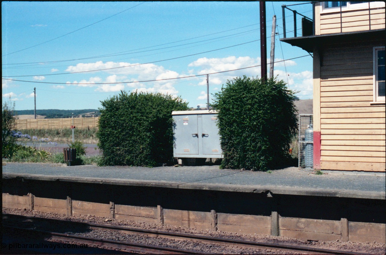 145-16
Wallan, up or No.2 platform, showing electrical cabinet, hedge, platform coping and bin.
