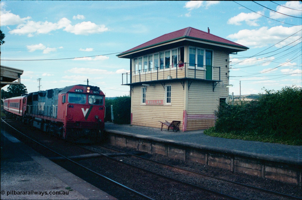145-19
Wallan elevated signal box overview, broad gauge V/Line N class N 471 'City of Benalla' Clyde Engineering EMD model JT22HC-2 serial 87-1200 leads an up express passenger service with N set as the signaller watches through the window of the elevated signal box.
Keywords: N-class;N471;Clyde-Engineering-Somerton-Victoria;EMD;JT22HC-2;87-1200;