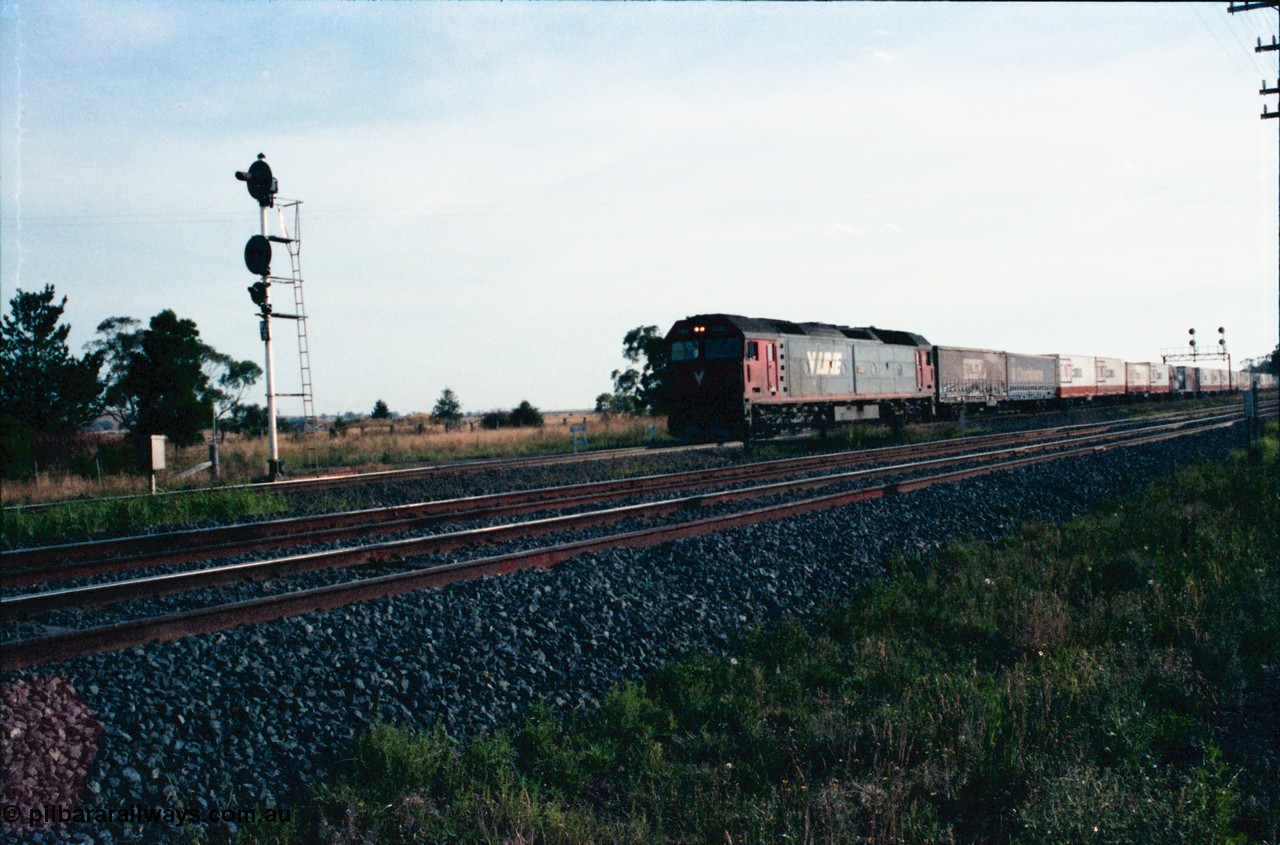 145-24
Wallan Loop, north end of standard gauge loop, broad gauge tracks in front, V/Line G class G 522 Clyde Engineering EMD model JT26C-2SS serial 86-1235 is crossing Boundary Rd with a down north bound goods.
Keywords: G-class;G522;Clyde-Engineering-Rosewater-SA;EMD;JT26C-2SS;86-1235;