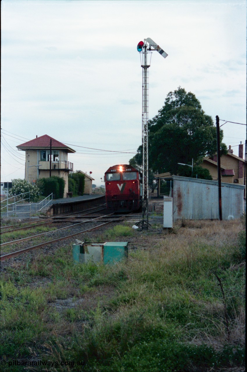 145-28
Wallan, down broad gauge Seymour passenger train hauled by V/Line N class N 455 'City of Swan Hill' Clyde Engineering EMD model JT22HC-2 serial 85-1223, gangers trolley shed at right, semaphore signal post 4 pulled off, station building behind and elevated signal box on platform two and waiting room at left.
Keywords: N-class;N455;Clyde-Engineering-Somerton-Victoria;EMD;JT22HC-2;85-1223;