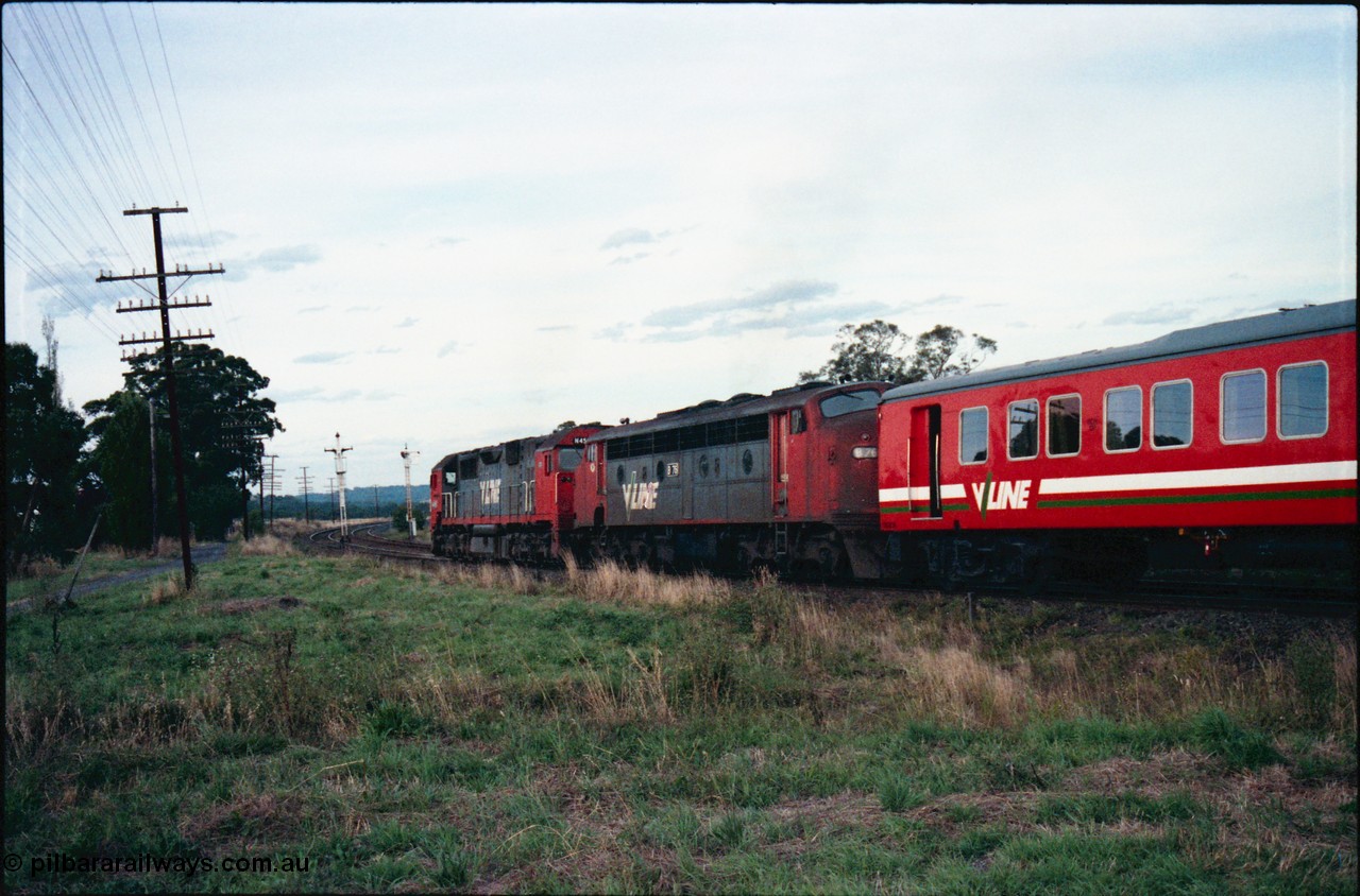 145-30
Wallan, down broad gauge Seymour pass hauled by V/Line N class N 455 'City of Swan Hill' Clyde Engineering EMD model JT22HC-2 serial 85-1223 and veteran B class B 76 Clyde Engineering EMD model ML2 serial ML2-17 with a H set, trailing view, shows discs removed off signal post 15 due to new crossover located near Boundary Rd.
Keywords: B-class;B76;Clyde-Engineering-Granville-NSW;EMD;ML2;ML2-17;bulldog;