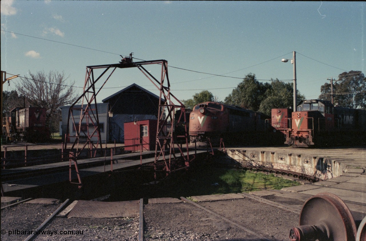 147-03
Seymour loco depot turntable overview of table and pit, broad gauge V/Line Y class Y 135 Clyde Engineering EMD model G6B serial 65-401 at left, workshop, CM parcel coach, S class S 317 ' Sir John Monash' Clyde Engineering EMD model A7 serial 61-240 and S 310 'George Higinbotham' serial 60-227, standard gauge Y class leader Y 101 serial 63-291 and broad gauge T class T 392 Clyde Engineering EMD model G8B serial 65-422.
Keywords: S-class;S317;Clyde-Engineering-Granville-NSW;EMD;A7;61-240;bulldog;