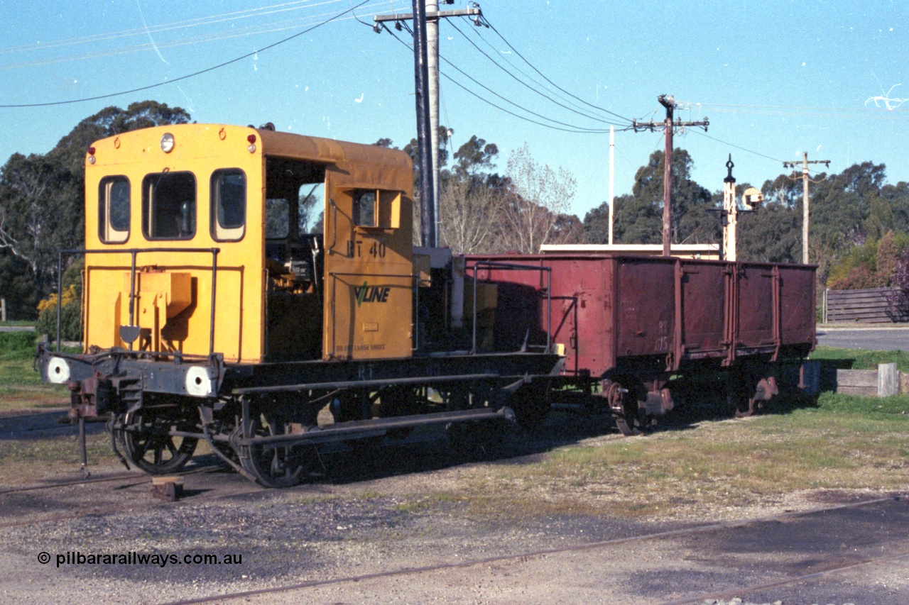 147-25
Seymour loco depot, broad gauge V/Line Rail Tractor RT 40 in yellow livery coupled to RY class open waggon RY 615. RT 40 was built in June 1967 at Ballarat North Workshops using the underframe of 1905 built I type I 7539 with was recoded to IA type in 1936. The RY started life in 1933 built as an IZ type, July 1966 recoded to RY.
Keywords: RT-class;RT40;RY-type;RY615;